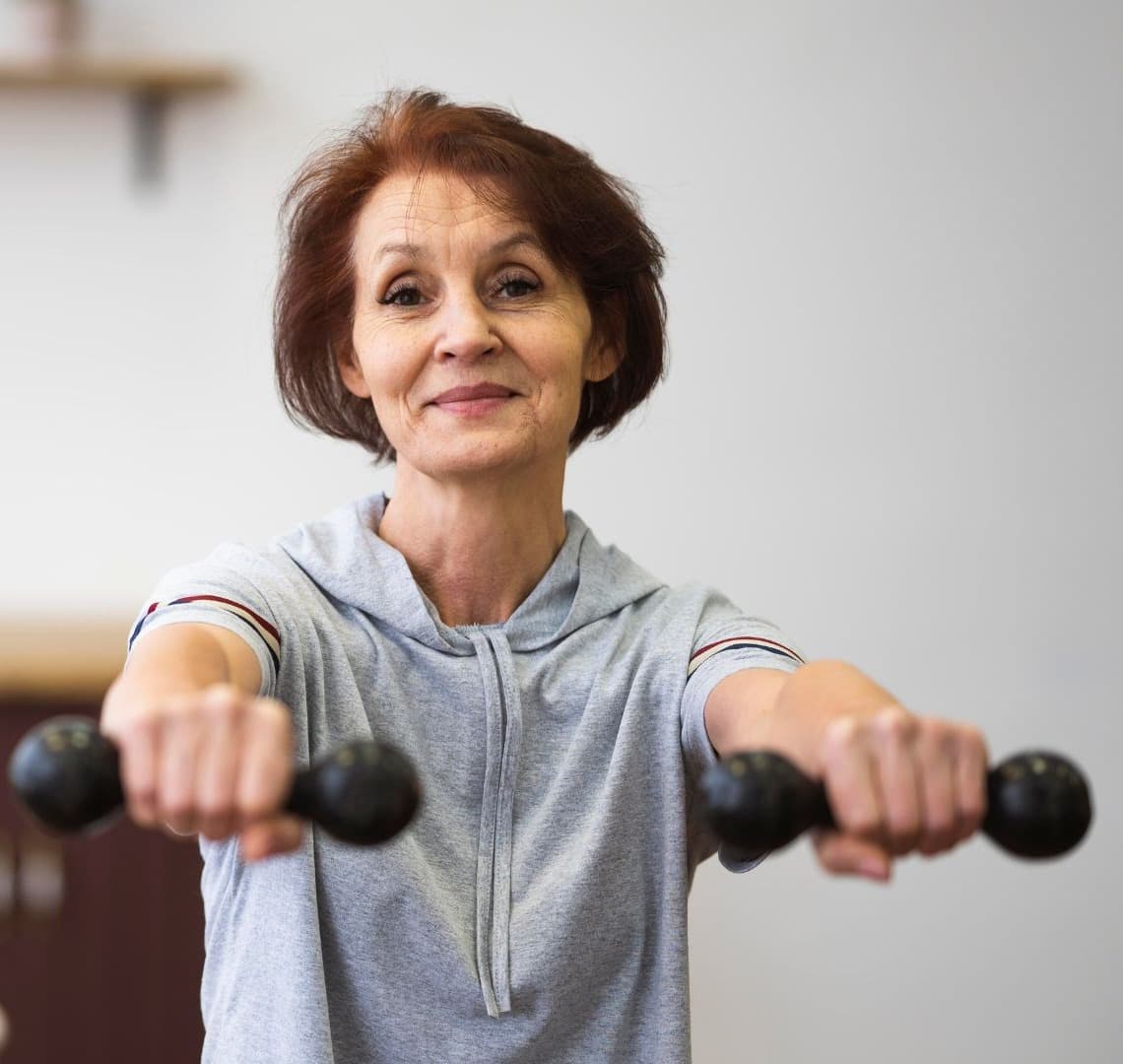 Older woman exercising with hand weights