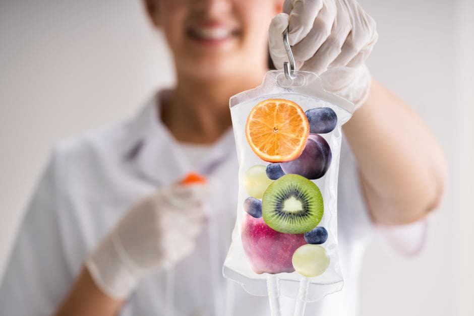 IV vitamin therapy bag with fresh fruit, held by a clinician