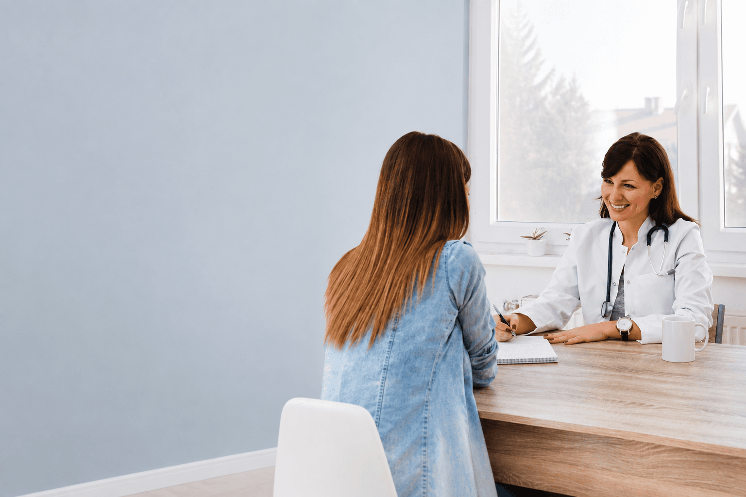 A physician listening closely to a patient during a consultation